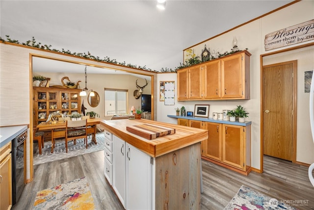 916 Sunset Dr, Brewster, WA 98812 - kitchen with wood counters, light wood-style flooring, black dishwasher, pendant lighting, and a center island