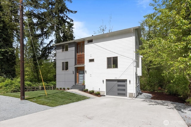 modern home featuring an attached garage, a front lawn, and concrete driveway