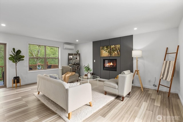 living room featuring baseboards, light wood-type flooring, recessed lighting, a wall unit AC, and a large fireplace