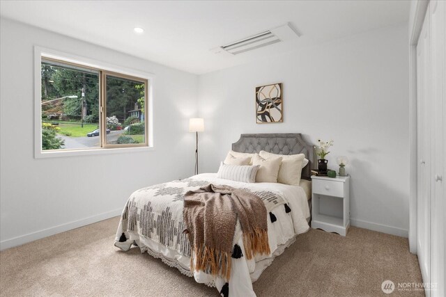 bedroom with carpet floors and baseboards