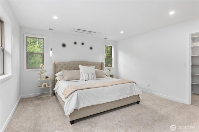 bedroom with carpet floors, recessed lighting, and multiple windows