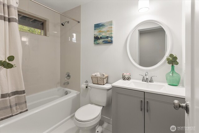 bathroom with toilet, shower / bathtub combination with curtain, and vanity