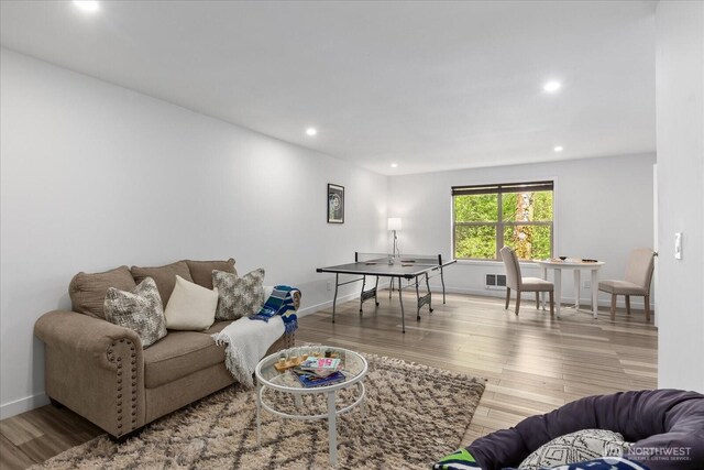 living area featuring baseboards, recessed lighting, and wood finished floors