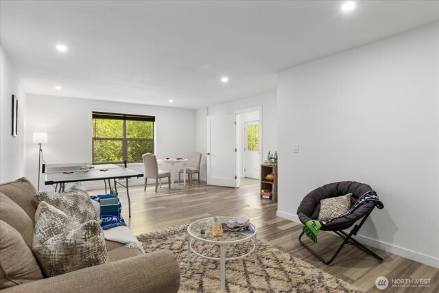 living area featuring recessed lighting, a healthy amount of sunlight, and light wood-style floors