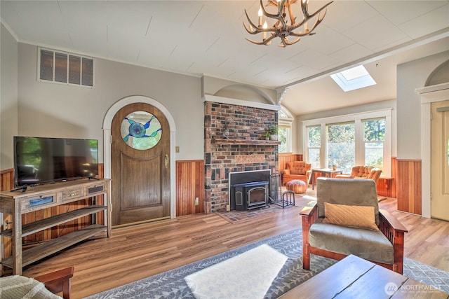 33823 State Route 706 Unit 1, Ashford, WA 98304 - living room with visible vents, a wood stove, wainscoting, wood finished floors, and a skylight