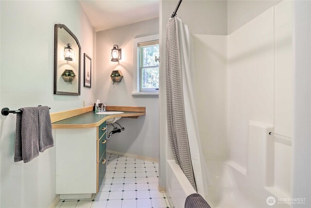 33823 State Route 706 Unit 1, Ashford, WA 98304 - full bath featuring baseboards, tile patterned floors, shower / bath combination with curtain, and vanity