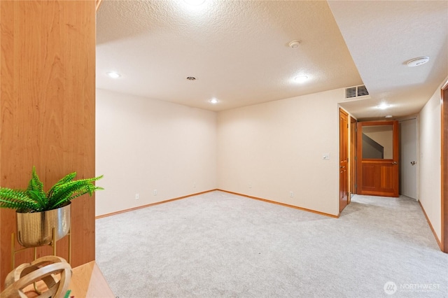 313 Willapa Pl, La Conner, WA 98257 - finished below grade area with light carpet, a textured ceiling, recessed lighting, baseboards, and visible vents