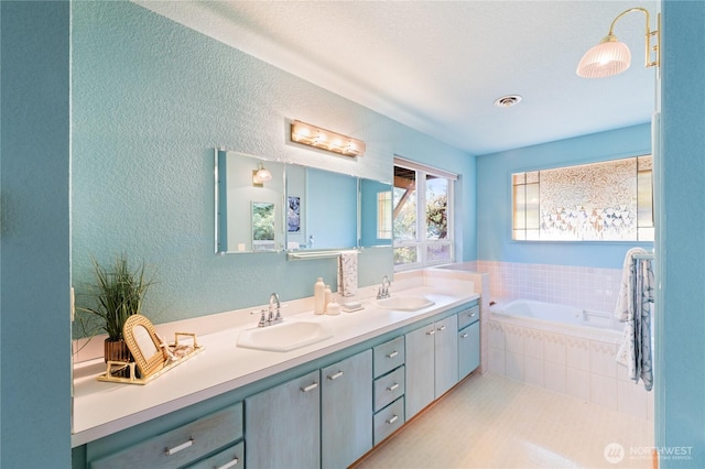 313 Willapa Pl, La Conner, WA 98257 - full bath with double vanity, a sink, a textured wall, and a bath