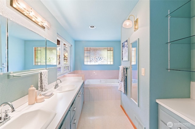 313 Willapa Pl, La Conner, WA 98257 - bathroom featuring double vanity, visible vents, a sink, and a bath