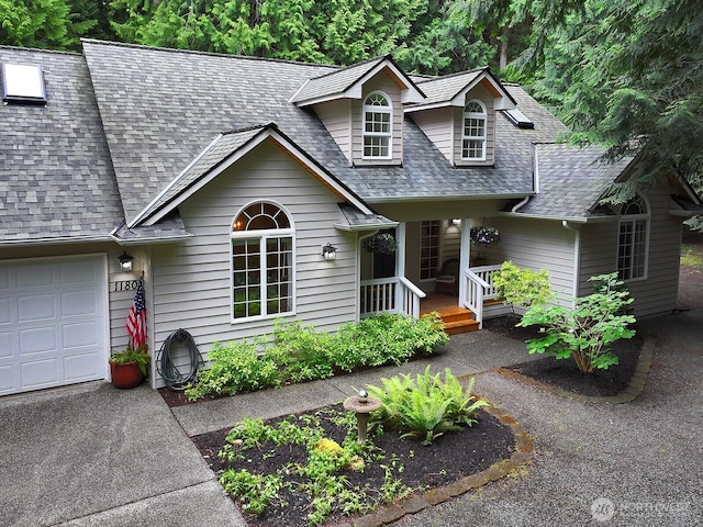 1180 Cedar Cir, Langley, WA 98260 - view of front of home featuring a shingled roof, a porch, and driveway