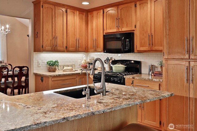 1180 Cedar Cir, Langley, WA 98260 - kitchen with black appliances, a sink, brown cabinetry, and light stone counters