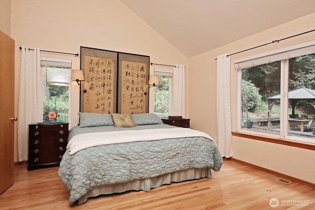 1180 Cedar Cir, Langley, WA 98260 - bedroom with wood finished floors, high vaulted ceiling, and baseboards