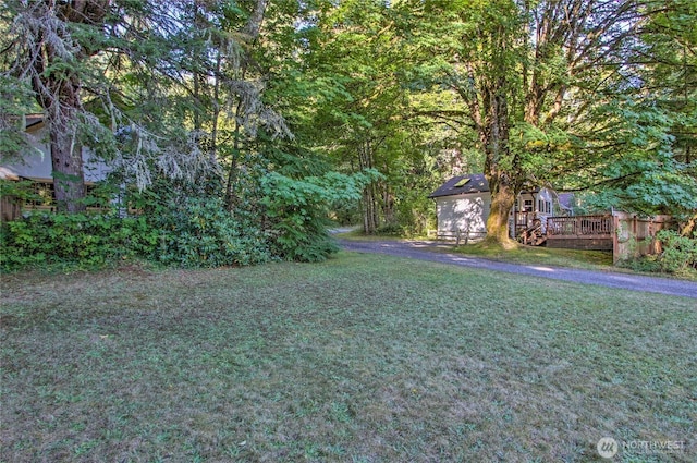 33823 State Route 706 E Unit 2, Ashford, WA 98304 - view of yard featuring a view of trees, a wooden deck, and an outbuilding