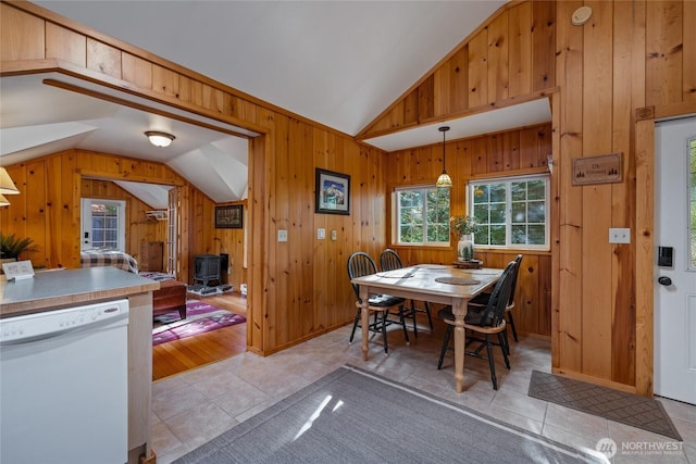 33823 State Route 706 E Unit 2, Ashford, WA 98304 - dining room featuring light tile patterned floors, a wood stove, vaulted ceiling, and wood walls