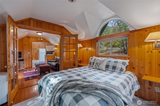33823 State Route 706 E Unit 2, Ashford, WA 98304 - bedroom with wood-type flooring, freestanding refrigerator, wood walls, and lofted ceiling