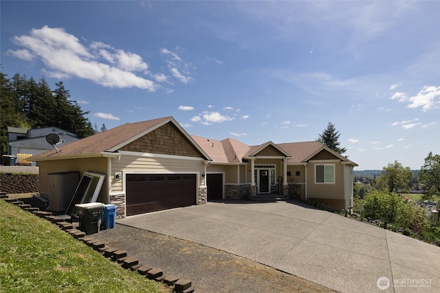 craftsman-style house featuring a garage, stone siding, and concrete driveway