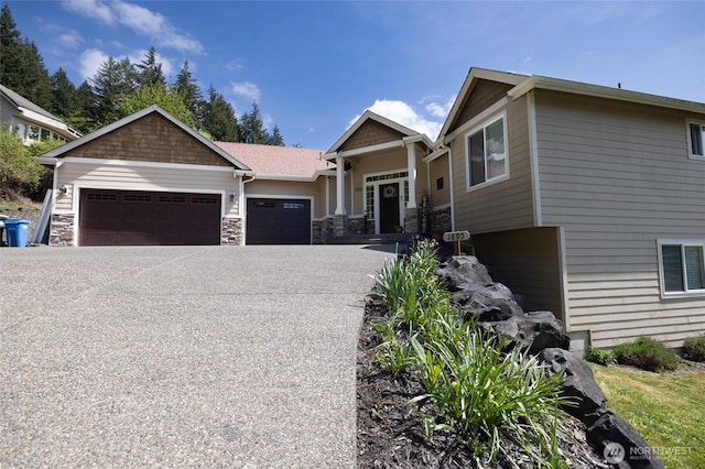 craftsman inspired home featuring a garage, stone siding, and concrete driveway