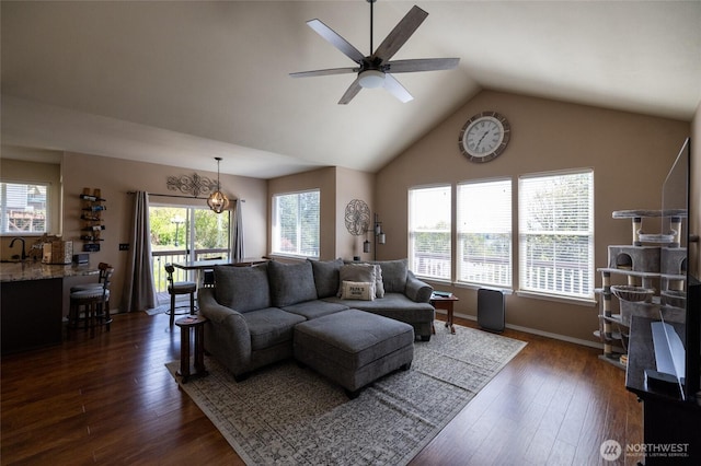 living room with ceiling fan, baseboards, lofted ceiling, and dark wood-type flooring