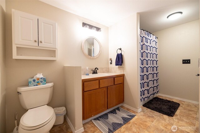 bathroom with vanity, toilet, and a shower with curtain