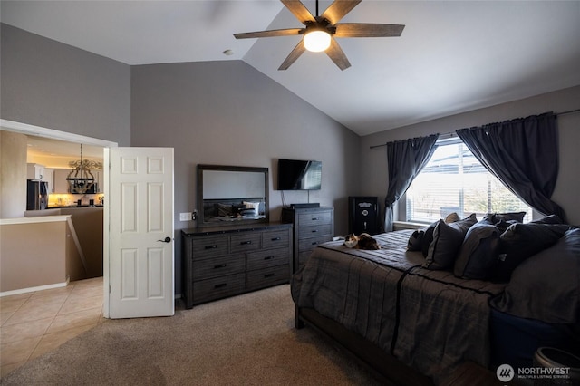 bedroom featuring light colored carpet, ceiling fan with notable chandelier, light tile patterned floors, lofted ceiling, and fridge with ice dispenser