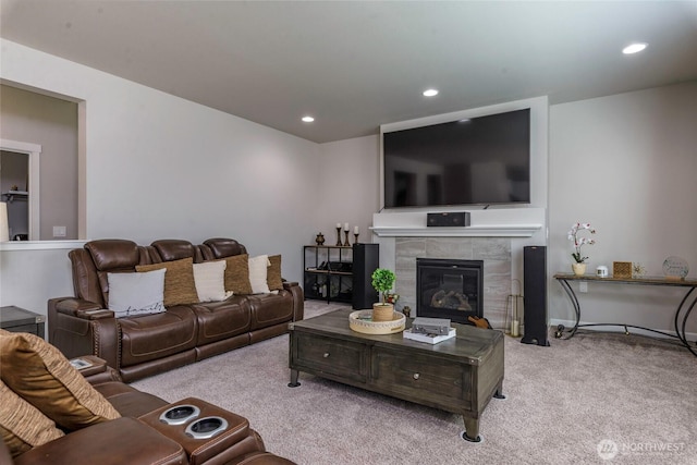 carpeted living area featuring a tiled fireplace and recessed lighting