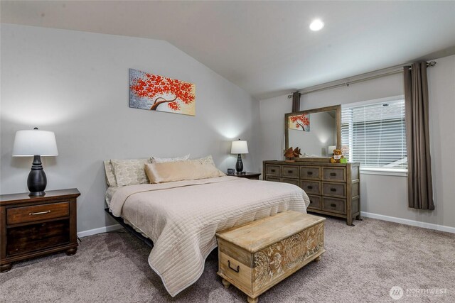 bedroom with baseboards, lofted ceiling, and light carpet