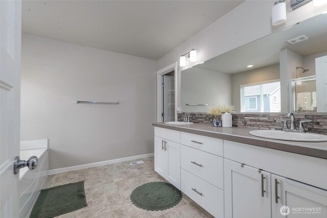 full bath with visible vents, a sink, an enclosed shower, and tasteful backsplash