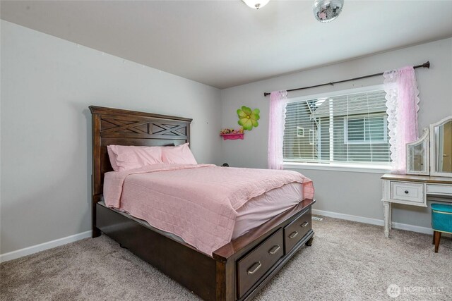 bedroom with baseboards and light carpet
