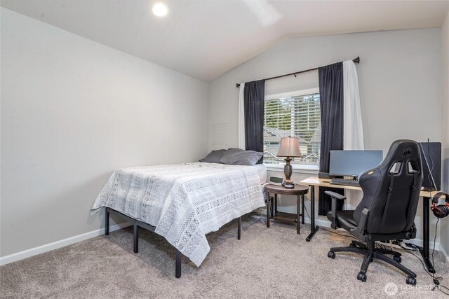 carpeted bedroom featuring baseboards and lofted ceiling