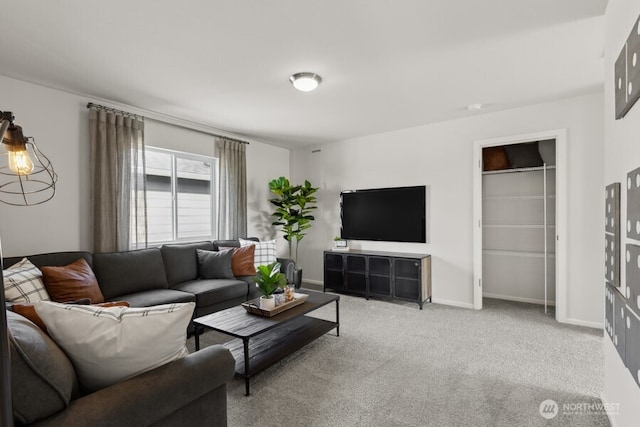 carpeted living room featuring baseboards