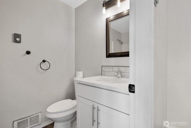 half bath with vanity and toilet
