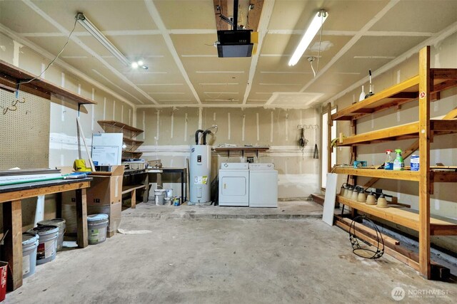 below grade area with electric water heater, a workshop area, and separate washer and dryer