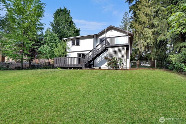 back of house featuring a wooden deck and stairway