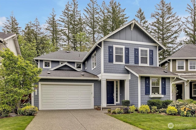 craftsman-style house with a garage, a shingled roof, concrete driveway, and a front yard