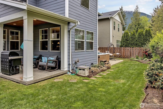 exterior space featuring fence, a lawn, and a patio area