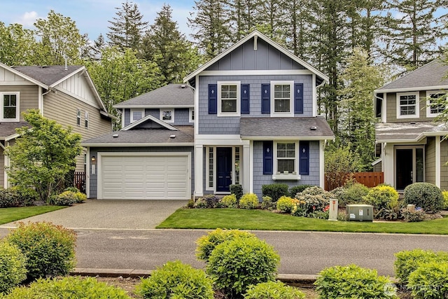 view of front of property featuring fence, roof with shingles, a garage, board and batten siding, and concrete driveway
