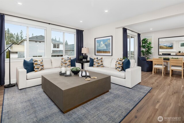 living area with recessed lighting and wood finished floors