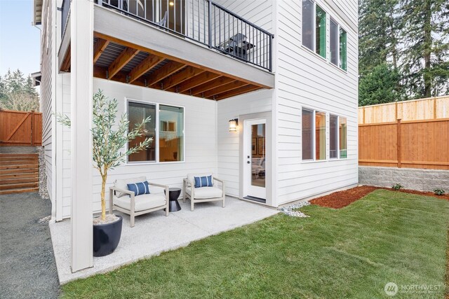 exterior space with a fenced backyard and a balcony