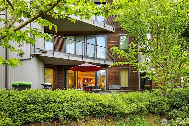 back of property featuring a balcony