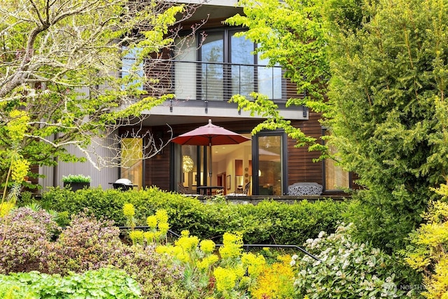rear view of house featuring a balcony