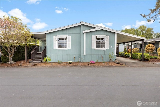 view of front of house featuring an attached carport and driveway