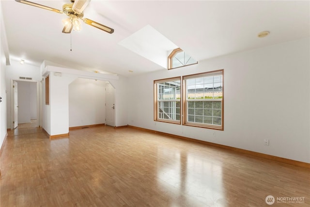 unfurnished room with light wood-type flooring, baseboards, ceiling fan, and lofted ceiling
