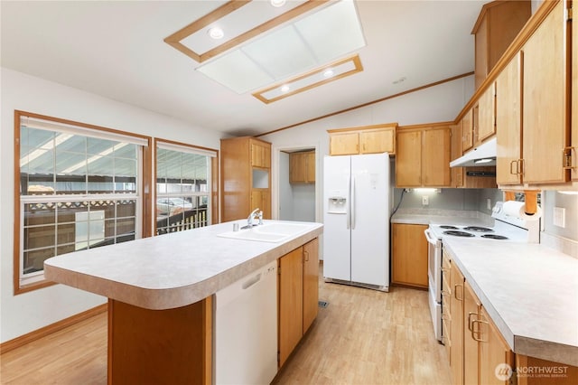 kitchen featuring white appliances, vaulted ceiling, a sink, and light wood-style floors