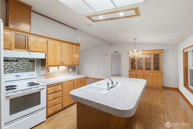 kitchen featuring electric range, a sink, light wood finished floors, under cabinet range hood, and vaulted ceiling