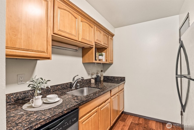 kitchen with a sink, freestanding refrigerator, dark wood-style floors, dark stone countertops, and dishwasher