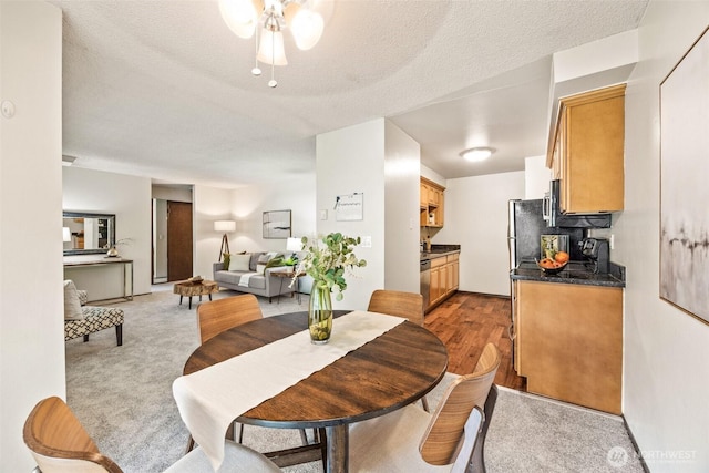 dining area with a textured ceiling and ceiling fan