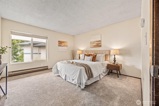 bedroom featuring a baseboard heating unit, carpet flooring, a textured ceiling, and baseboards