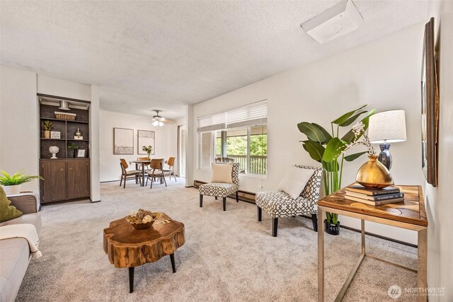 carpeted living room featuring a textured ceiling and a baseboard radiator