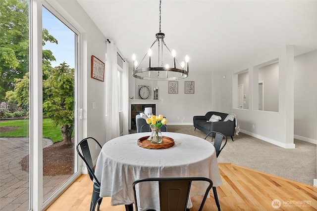 dining area featuring baseboards and a chandelier