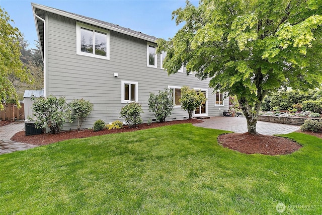 rear view of property with a patio area, fence, and a yard